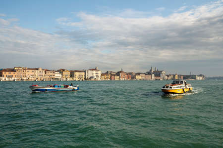 Lagoon of Venice with it characteristic cityscape and motorboats in front that are used for passenger transportsのeditorial素材