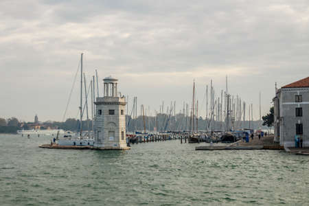 View on the the Faro San Giorgio Maggiore in Venice with the lagoon and boats in the backgroundの写真素材