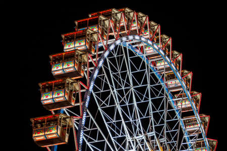 Munich, Germany - September 26, 2015: Ferris wheel on the fairground of the Octoberfest in Munich at nightのeditorial素材