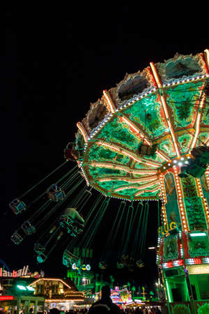 Munich, Germany - September 26, 2015: Nightshot of the Wellenflug carousel in motion at Oktoberfest on Theresienwieseのeditorial素材
