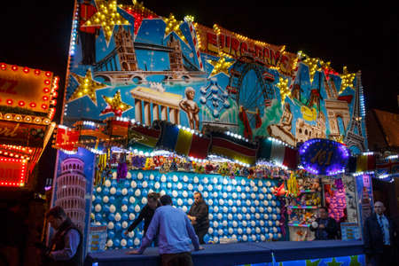 Munich, Germany - September 26, 2015: Gallery for throwing arrows on balloons at Oktoberfest with unidentified people preparing for the shotsのeditorial素材