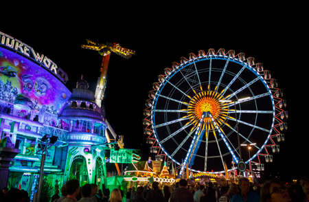 Munich, Germany - September 26, 2015: Ferris wheel on the fairground of the Octoberfest in Munich at nightのeditorial素材