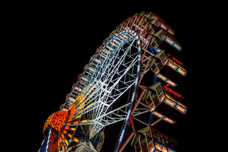 Munich, Germany - September 26, 2015: Ferris wheel on the fairground of the Octoberfest in Munich at nightのeditorial素材