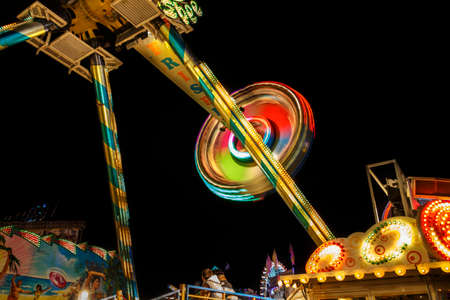 Munich, Germany - September 26, 2015: Frisbee fun ride in motion with people flying through the air on Theresienwieseのeditorial素材