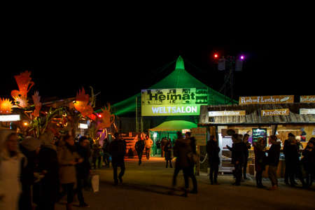 Munich, Germany - November 30, 2016: Tollwood winter festival and christmas market in Munich during the evening hours with illuminated tents and barsのeditorial素材
