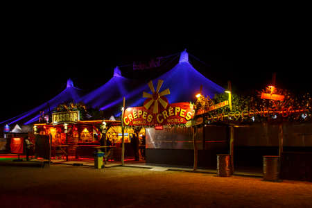 Munich, Germany - November 30, 2016: Tollwood winter festival and christmas market in Munich during the evening hours with illuminated tents and barsのeditorial素材