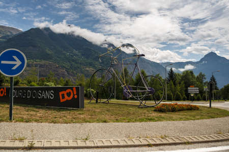Le Bourg-d'Oisans, France - August 19, 2019: Roundabout with a large bicycle sculpture dedicated to the famous village at the bottom of the climb to L'Alpe d'Huezのeditorial素材