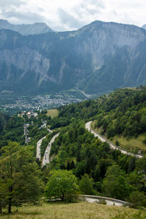 L'Alpe d'Huez, France - August 19, 2019: Ascent of the famous route to L'Alpe d'Huez and itinerary of the Tour de France with Le Bourg-d'Oisans at the bottom of the climbのeditorial素材