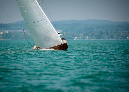 Classic sailing boats are very popular at at the lakes in the alpine regionの写真素材