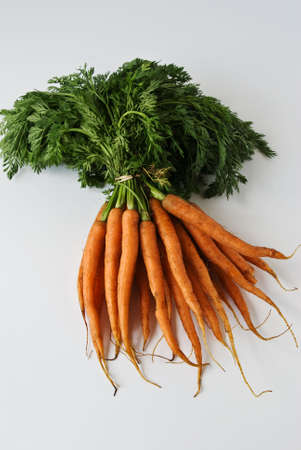 A bunch of carrots await washing and cookingの写真素材
