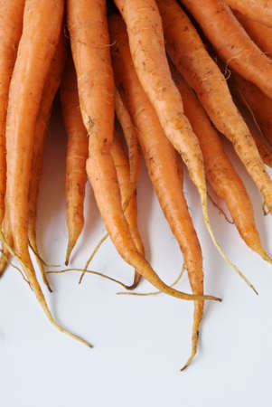 A bunch of carrots await washing and cookingの写真素材