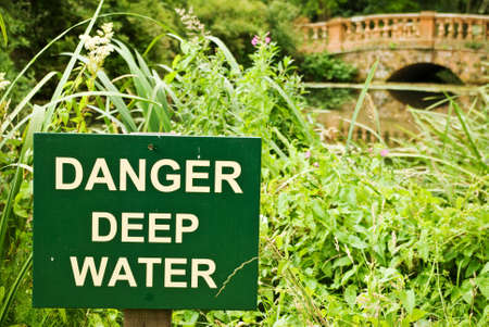 A sign clearly spells out the dangers in this idylic locationの写真素材