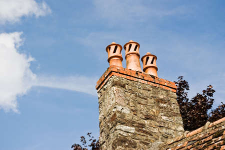 A trio of classic French chimney pots against a summer skyの写真素材