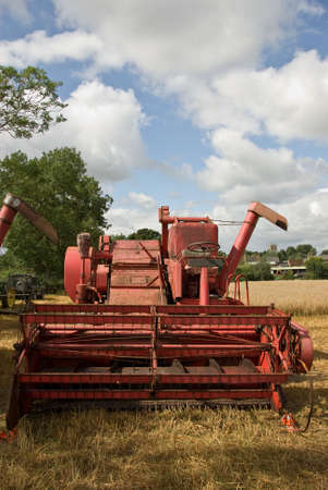 A classic combine harvester in a summer field