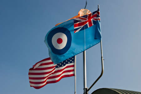 A pair of symbolic flags flying at an old world war two airfield
