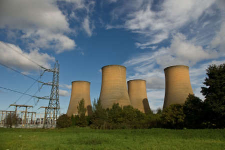 The cooling towers of a power station against a blue skyの写真素材