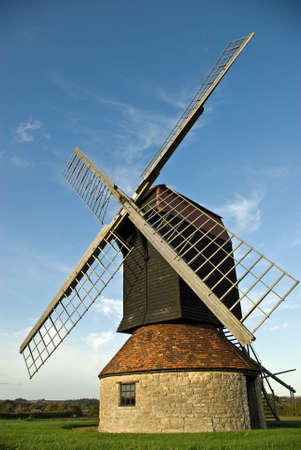 A restored windmill tops a hill in the English countrysideの写真素材