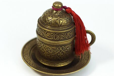 metal cup of coffee with the Turkish motif on white backgroundの写真素材