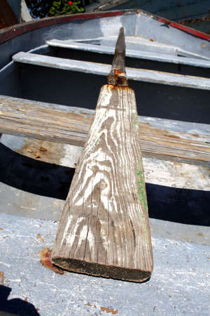 Old row boat with a worn oar.の写真素材