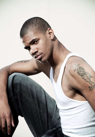 Handsome African American male model posed in front of a white background. Green filter effects added.の写真素材