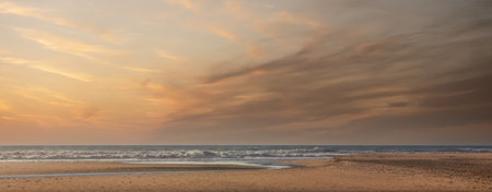 Minimalist seascape at sunrise with colorful cloudy sky. Beautiful panoramic view over the Atlantic...