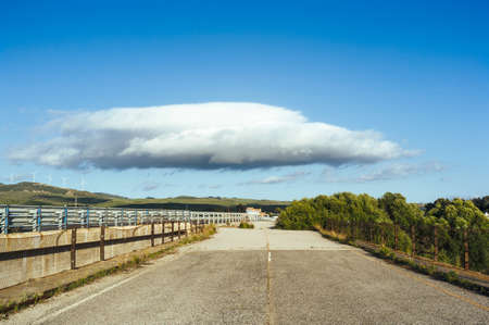 Abandoned road and a big stratus cloud, natural landscapeの写真素材