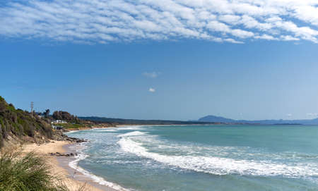 Picturesque scenery of waving sea and sandy Los Lances beach under blue sky with cirrocumulus clouds in Tarifa summer. Cadiz coastline, Andalusia, Spainの写真素材