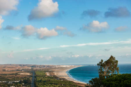 Amazing aerial view of Tarifa coastline. Magnificent drone view of the long gold sandy Los Lances beach on sunny day. Cadiz, Andalusia, Spainの写真素材