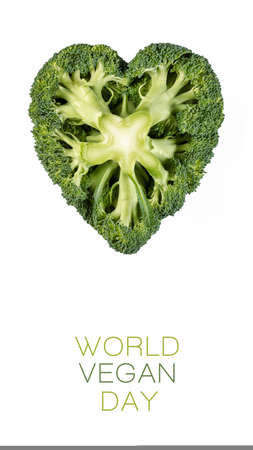 World Vegan day poster design with heart shaped head of farm fresh broccoli showing the stem isolated on white with text and copy space below in vertical formatの写真素材