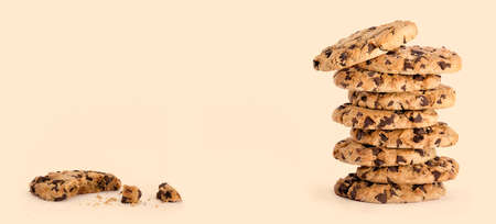 Cookie day banner with delicious freshly baked chocolate chip cookies in a tall stack, next to a...