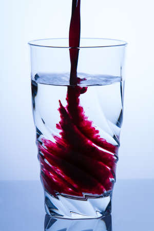 Pouring aronia juiceの写真素材