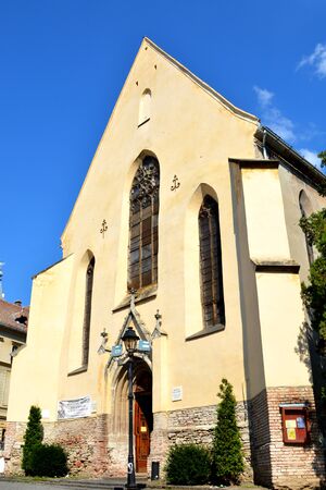 Church in center of Sighisoara. Urban landscape in the downtown of the medieval Sighisoara, Transylvania.の写真素材