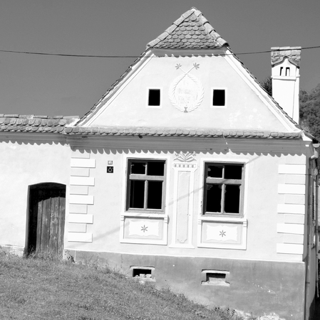 Typical house in the village Malancrav.  Fortified medieval church in the village Malancrav, Transylvania.のeditorial素材