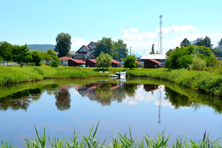 Lake in the transylvanian plain, a summer day and white clound on the blue skyの写真素材