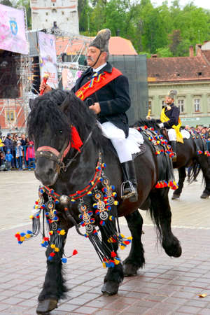 Riders celebrating of the day so call Juni men. A millennial  romanian tradition in Brasov, Transylvania.のeditorial素材