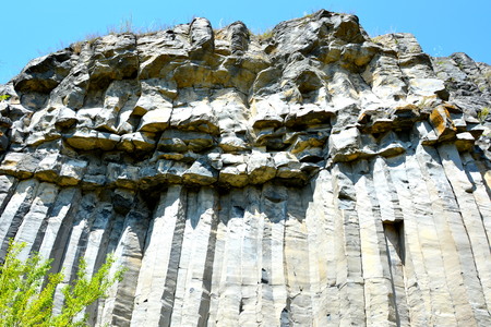 Basalt columns rocks in Racos, Transylvania Basalt Rocks are volcanic rock outcrops in the form of...