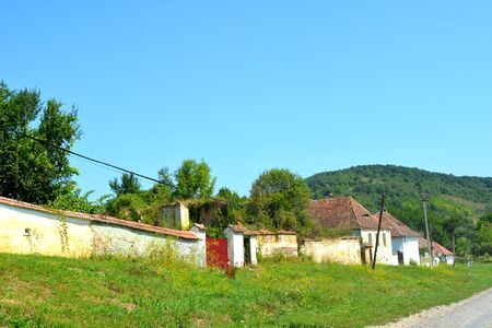 Typical rural landscape in the plains of Transylvania, Romania. Green landscape in the midsummer, in a sunny day. Village Somartinの写真素材