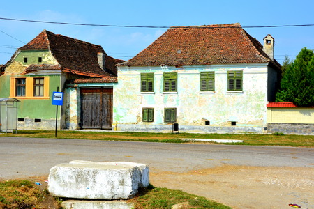 Typical rural landscape and peasant houses in  the village Mercheasa, Transylvania, Romania. The settlement was founded by the Saxon colonists in the middle of the 12th centuryの写真素材