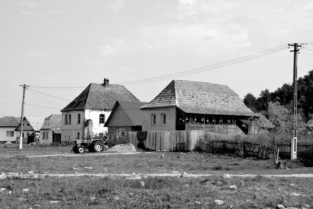 Typical rural landscape and peasant houses in  the village Mercheasa, Transylvania, Romania. The settlement was founded by the Saxon colonists in the middle of the 12th centuryの写真素材