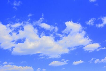 White clouds in a blue sky in a cloudy summer dayの写真素材