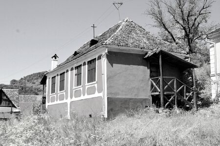 Typical rural landscape and peasant houses in  the village Alma Vii (Almen) Transylvania, Romania. The settlement was founded by the Saxon colonists in the middle of the 12th centuryの写真素材