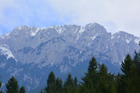 Piatra Craiului in Carpathian Mountains, Transylvania. Typical landscape in the forests of  Romania. Green landscape in spring, in a sunny dayの写真素材