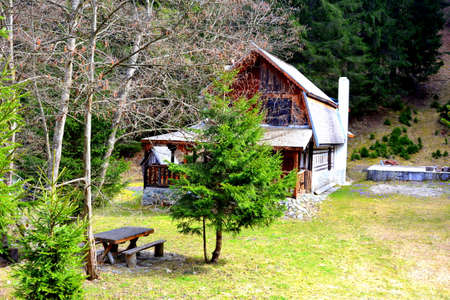 Chalet in Piatra Craiului in Carpathian Mountains, Transylvania. Typical landscape in the forests of  Romania. Green landscape in spring, in a sunny dayのeditorial素材