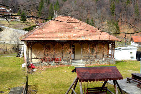 Chalet in Piatra Craiului in Carpathian Mountains, Transylvania. Typical landscape in the forests of  Romania. Green landscape in spring, in a sunny dayのeditorial素材