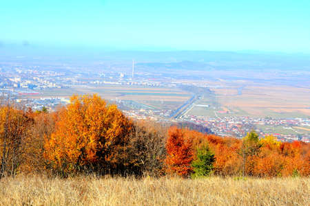 Autumn landscape in the mountains. View from the hill to the city.の写真素材