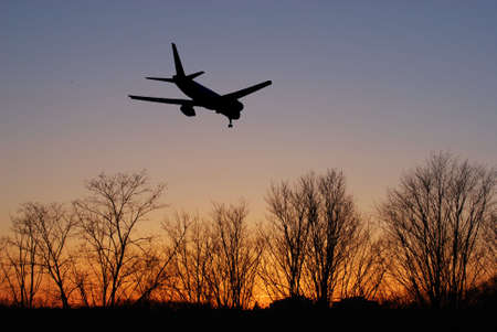 Airliner landing at sunriseの写真素材