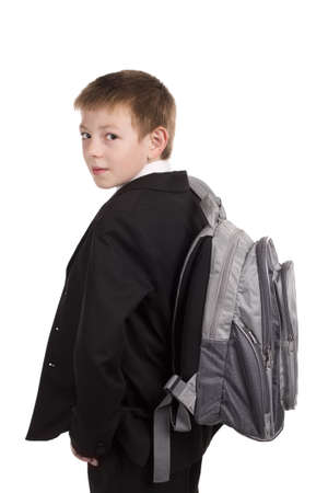 Schoolboy with backpack looking at camera isolated on white background 