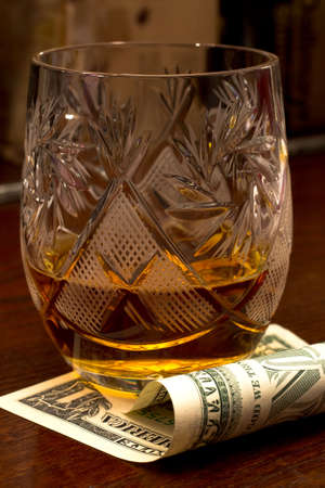 Whiskey glass and money の写真素材