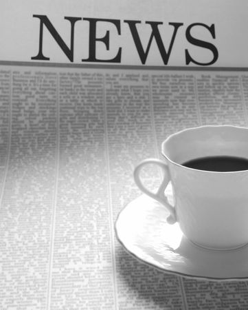 coffee cup on a newspaper page. news on breakfast. の写真素材