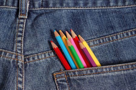 some crayons on a jeans backgroundの写真素材